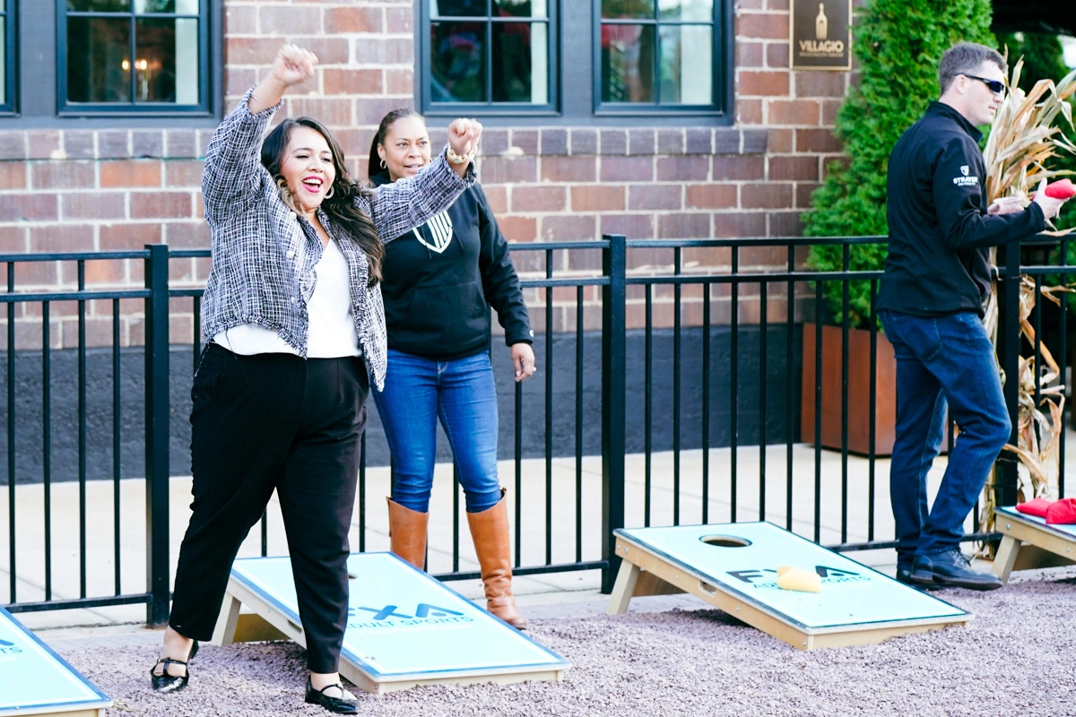 happy people playing cornhole at a corporate event